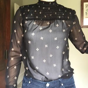 Sheer black top with ruffle neck